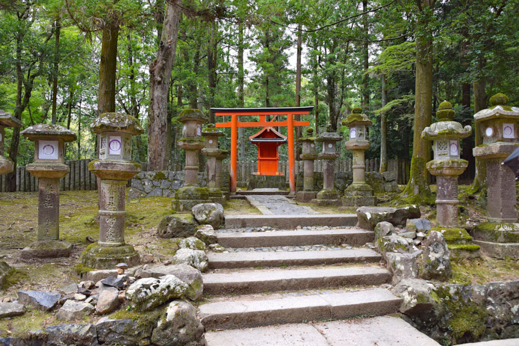 Red torii gate and lanterns around Kasuga Taisha in Nara Park