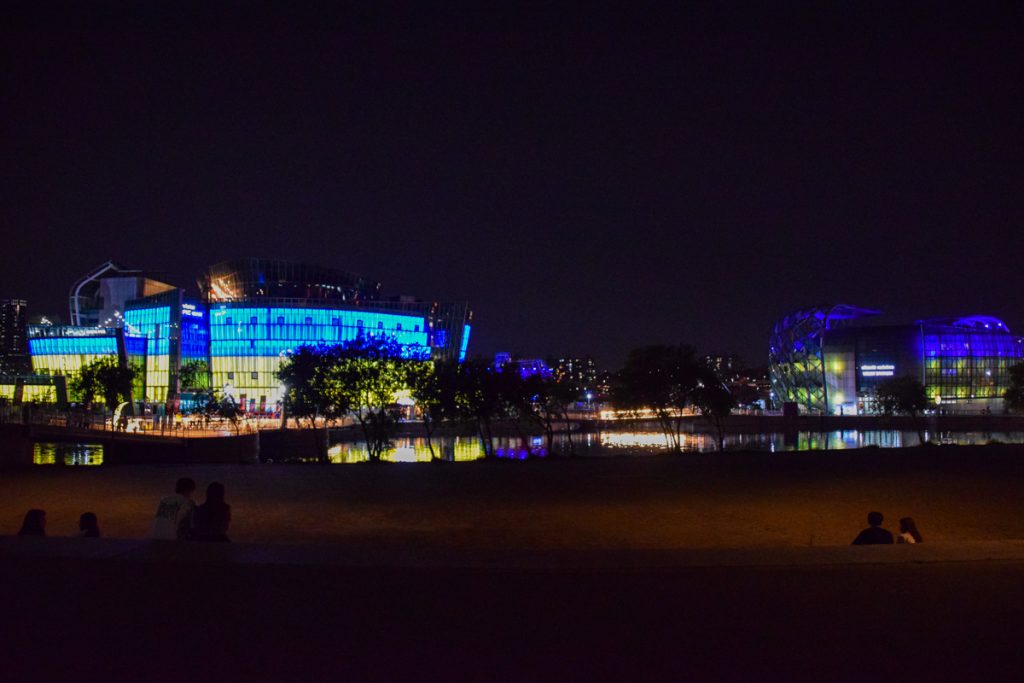 The floating islands lit up blue and yellow at night at Banpo Park